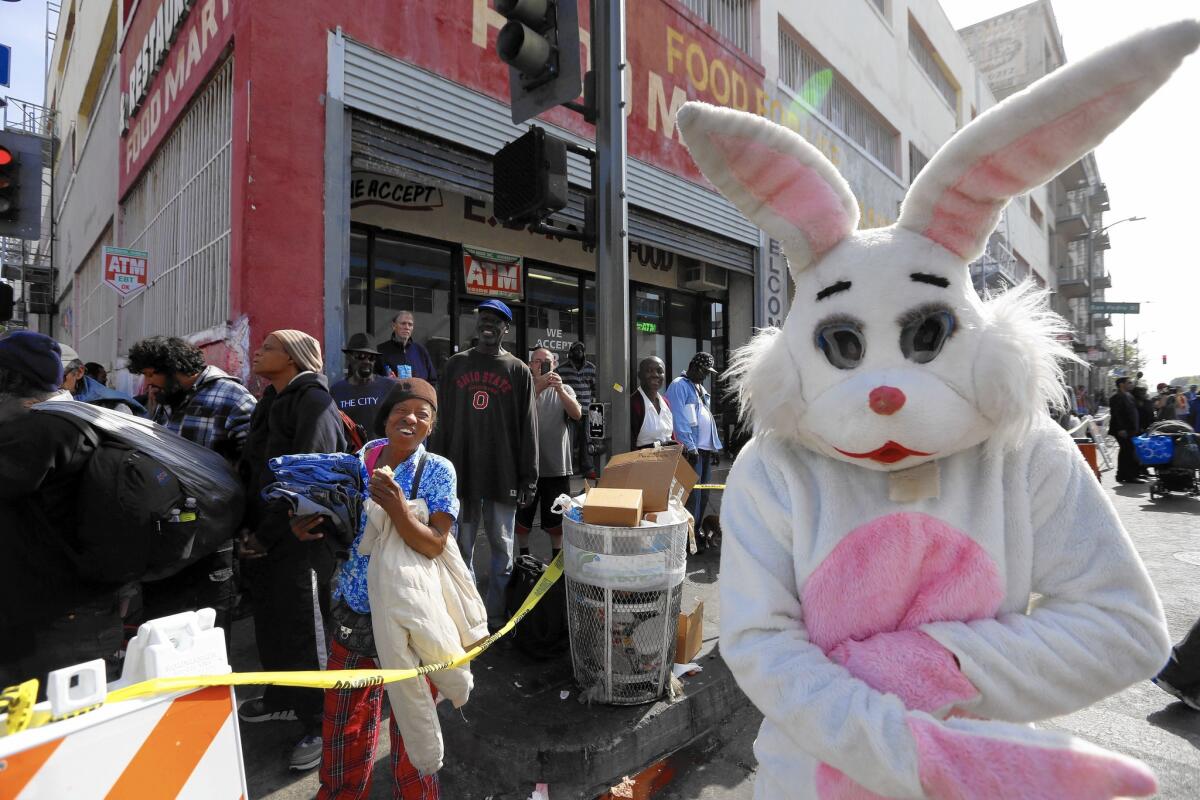 Logan Hobson, 61, of Playa del Rey greets people and hands out candy in his role as the Easter Bunny at the Midnight Mission's Easter and Passover brunch in skid row Sunday.