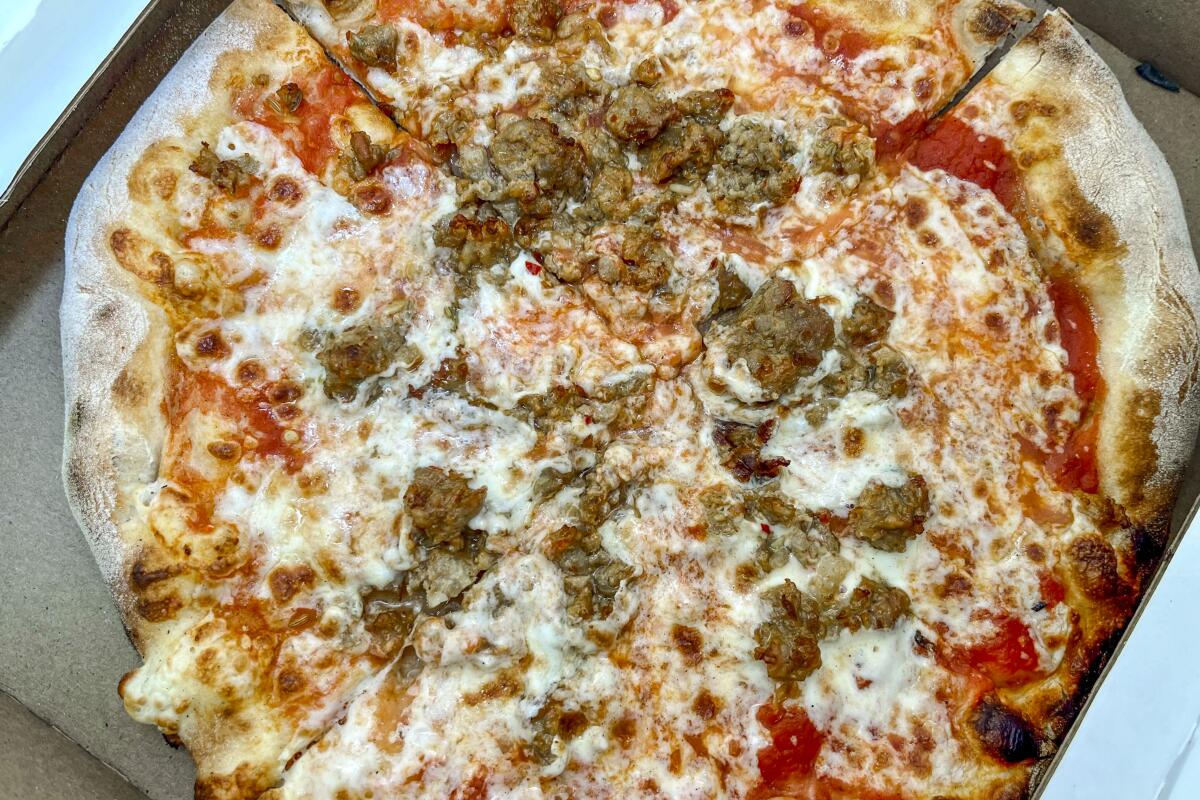The salsiccia pizza at Napolini Pizzeria has the right ratio of sausage, toasted bell peppers, mozzarella and sauce.