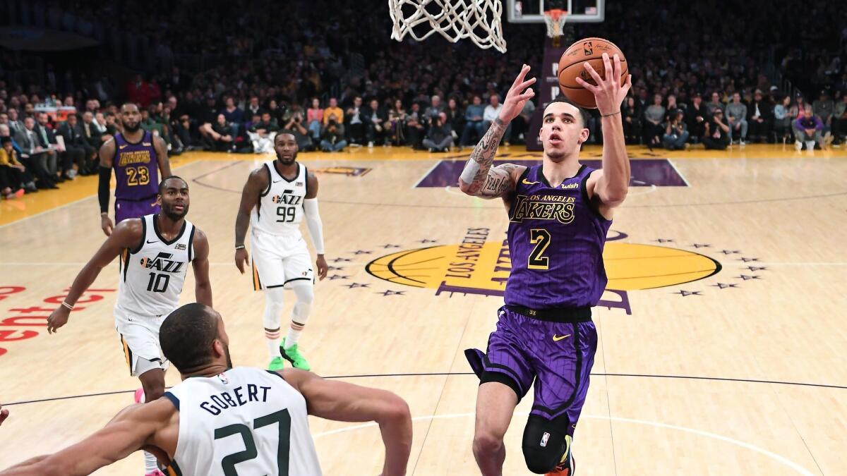 Lakers' Lonzo Ball scores drives to the basket for a layup against the Jazz.