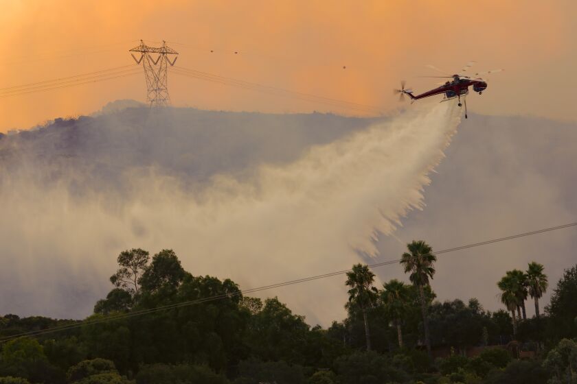 Large crane helicopters drop water on the Valley fire.