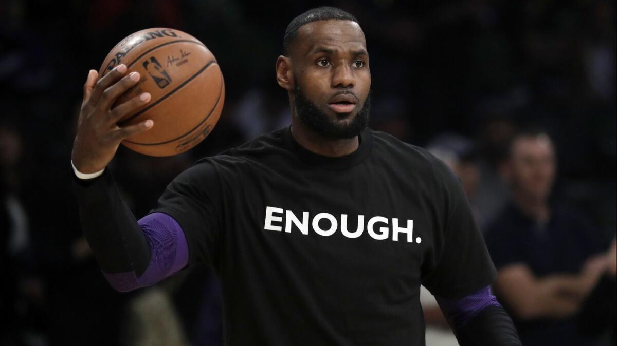 Lakers' LeBron James wears a t-shirt for the 12 victims of Wednesday night's shooting at Borderline Bar in Thousand Oaks before the game against the Atlanta Hawks on Sunday.