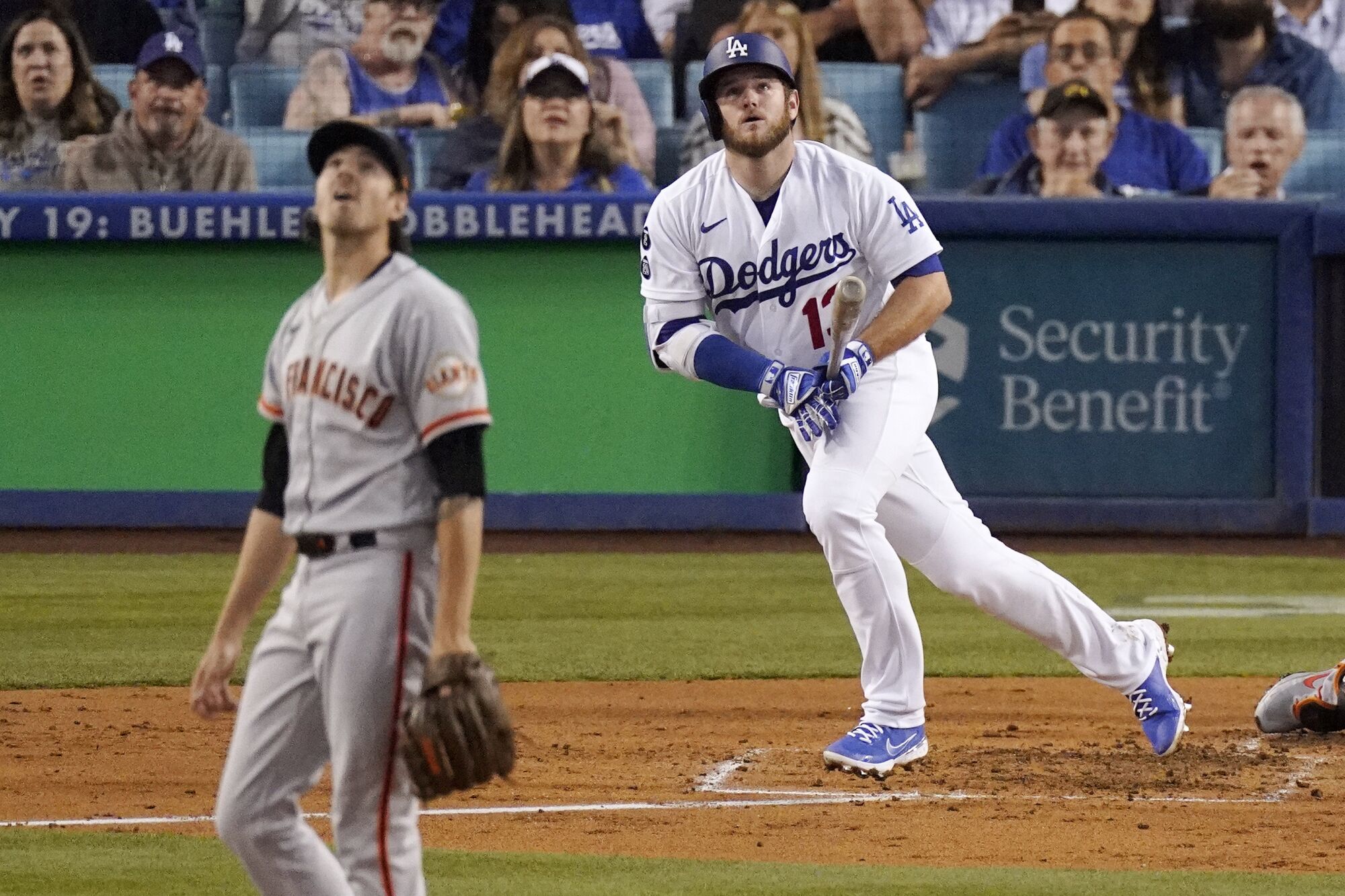 Dodgers' Max Muncy and Giants pitcher Kevin Gausman watch the home run Muncy hit off Gausman.