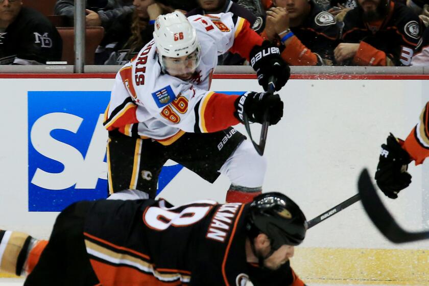 Calgary Flames center Josh Jooris, top, shoots over Ducks forward Tim Jackman during the Ducks' 3-0 victory in Game 2 of the Western Conference semifinals at Honda Center on Sunday.