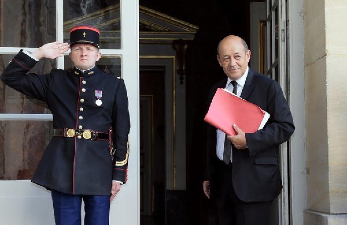 French Defense Minister Jean-Yves Le Drian arrives for a meeting Monday in Paris about possible military action by the French government against the Syrian regime.