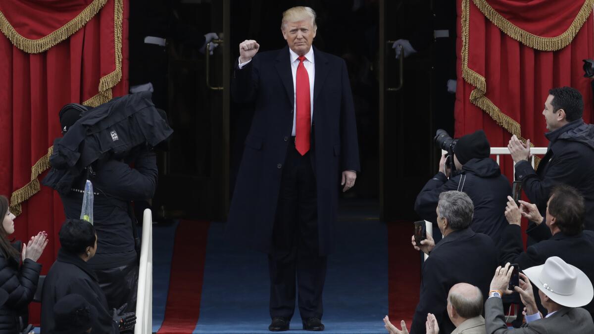 Donald Trump pumps his fist as he arrives for his presidential inauguration at the U.S. Capitol on Jan. 20, 2017.
