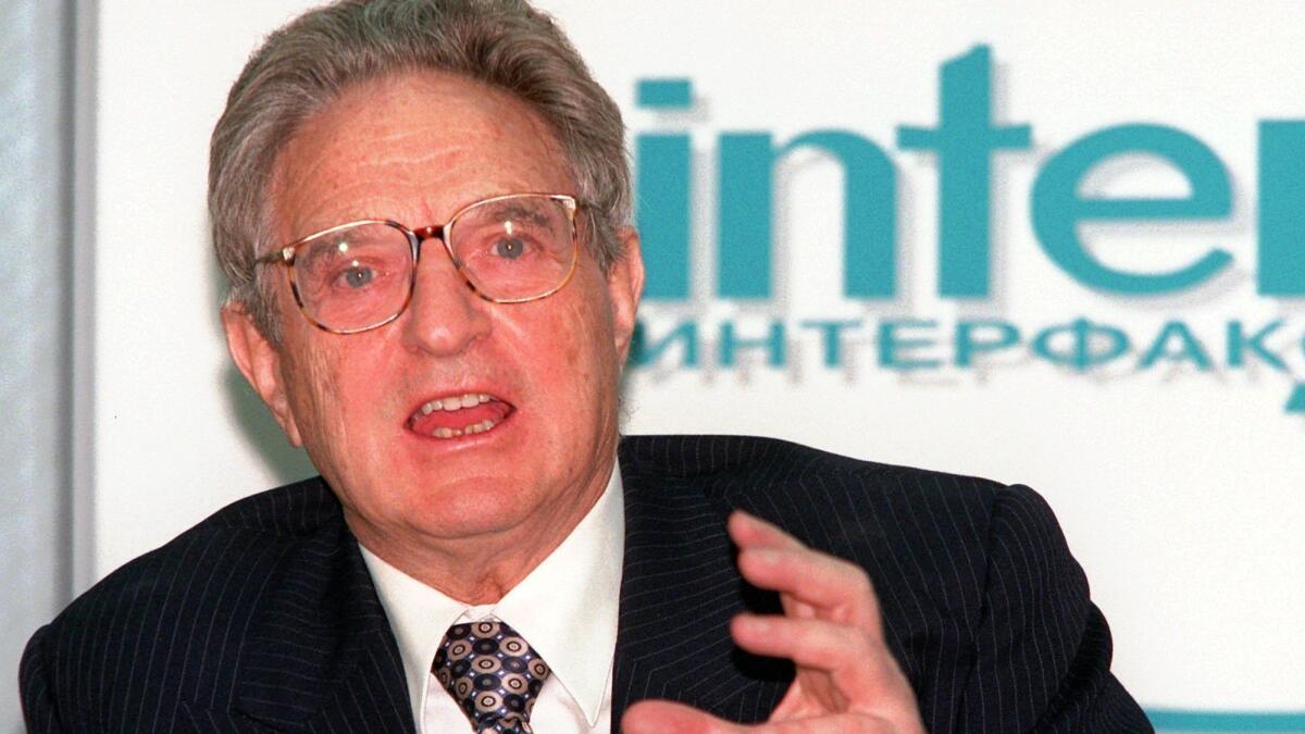 George Soros speaks to reporters in Moscow on March 4, 1998, when he pledged to contribute more than $100 million to Russian libraries, museums and health and education programs.