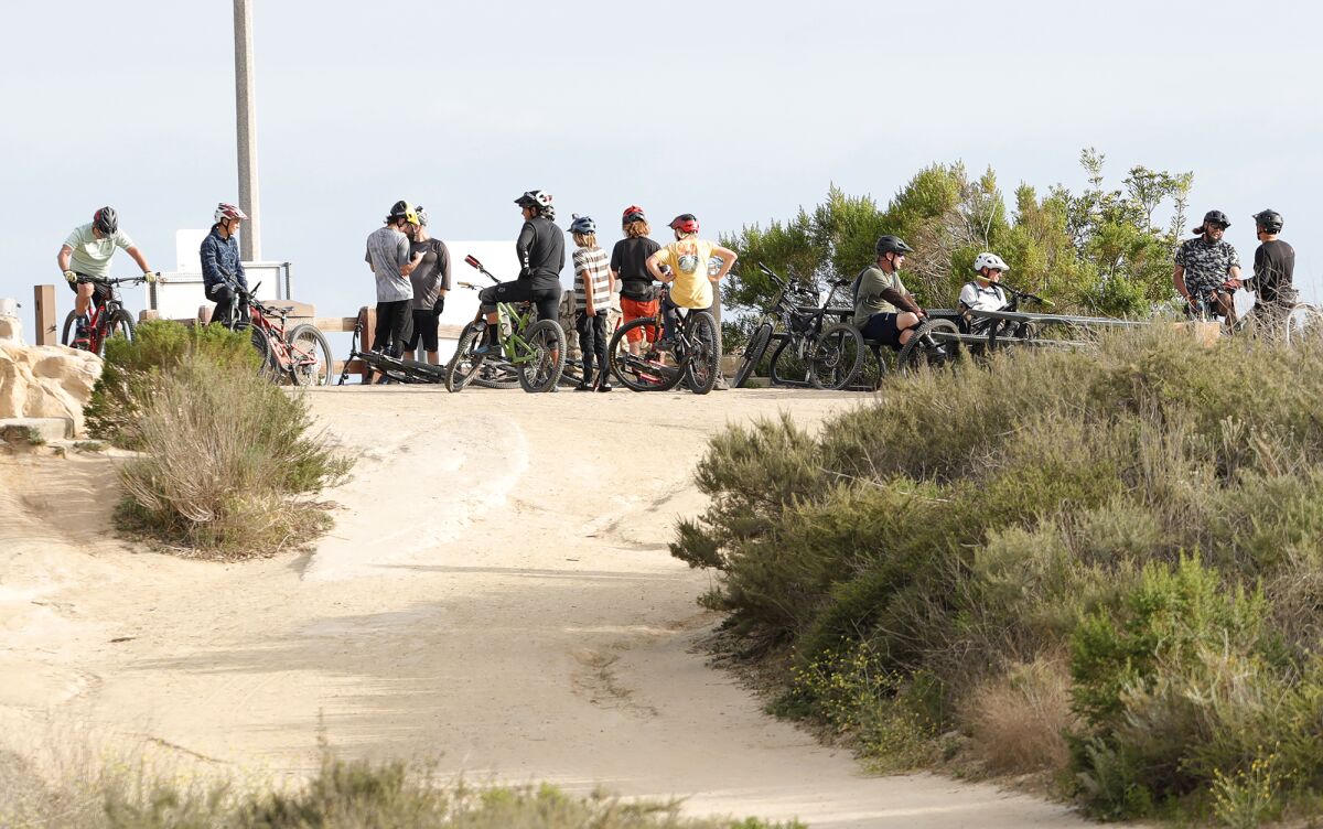 A group of mountain bikers take a break at the main trail at Top of the World in Laguna Beach on Wednesday, April 21.