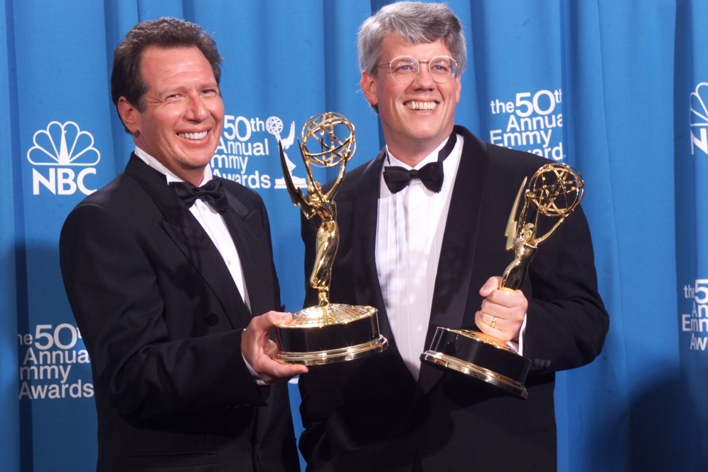 Shandling, left, and Peter Tolan show off their Emmys for Outstanding Writing for a Comedy Series during the 1998 Emmy Awards at the Shrine Auditorium.