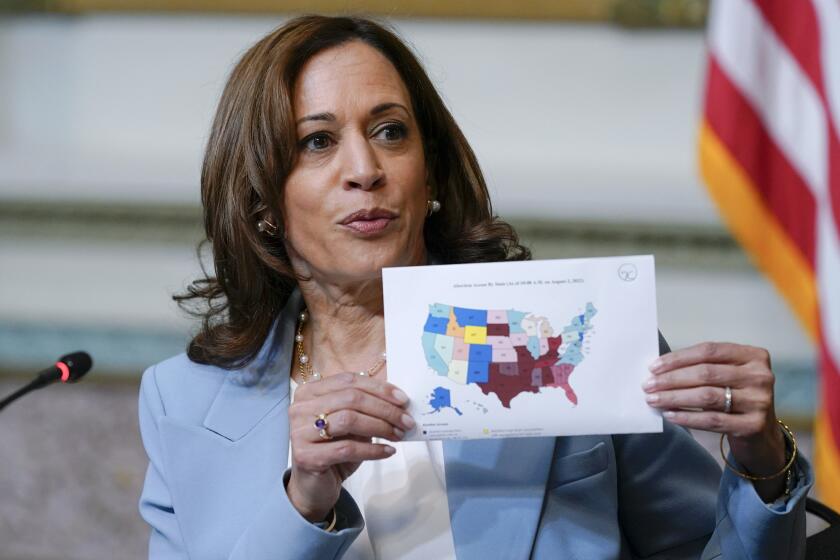 FILE - Vice President Kamala Harris displays a map showing abortion access by state as she speaks during the first meeting of the interagency Task Force on Reproductive Healthcare Access in the Indian Treaty Room in the Eisenhower Executive Office Building on the White House Campus in Washington, Aug. 3, 2022. Harris will speak about the abortion issue Sunday in Florida, where Democrats fear a renewed attempt to restrict abortion by Republican Gov. Ron DeSantis.(AP Photo/Susan Walsh, File)