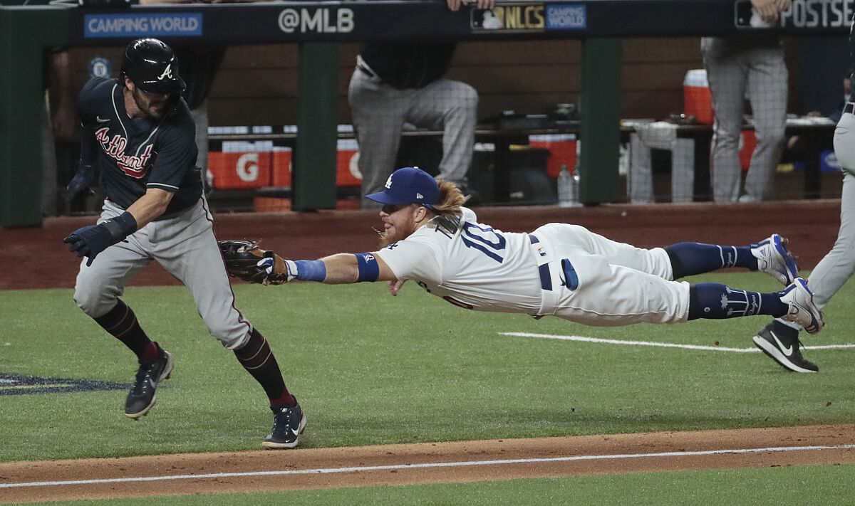 Dodgers third baseman Justin Turner stretches to tag out Braves shortstop Dansby Swanson in Game 7 of the 2020 NLCS