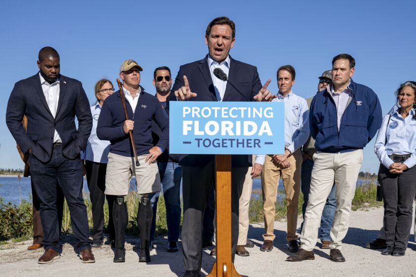 Florida Gov. Ron DeSantis speaks during a news conference with U.S. Reps. Byron Donalds, R-Fla., left, Brian Mast, R-Fla., third left, Sen. Marco Rubio, R-Fla., second right, and others at a stormwater treatment area in western Palm Beach County, Fla., on Monday, Jan. 31, 2022. (Greg Lovett/The Palm Beach Post via AP)