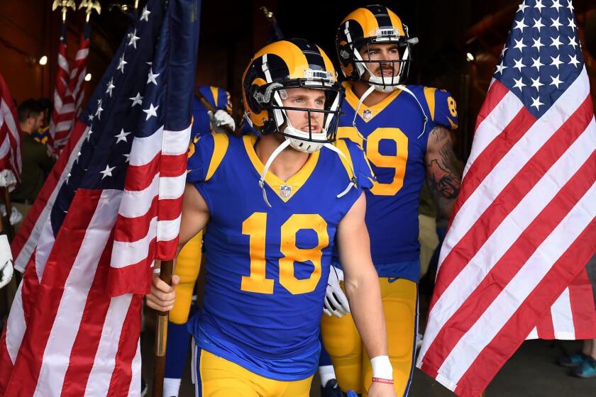 LOS ANGELES, CALIFORNIA NOVEMBER 11, 2018-Rams receiver Cooper Kupp carries the American flag before a game against the Seahawks at the Coliseum Sunday. (Wally Skalij/Los Angeles Times)