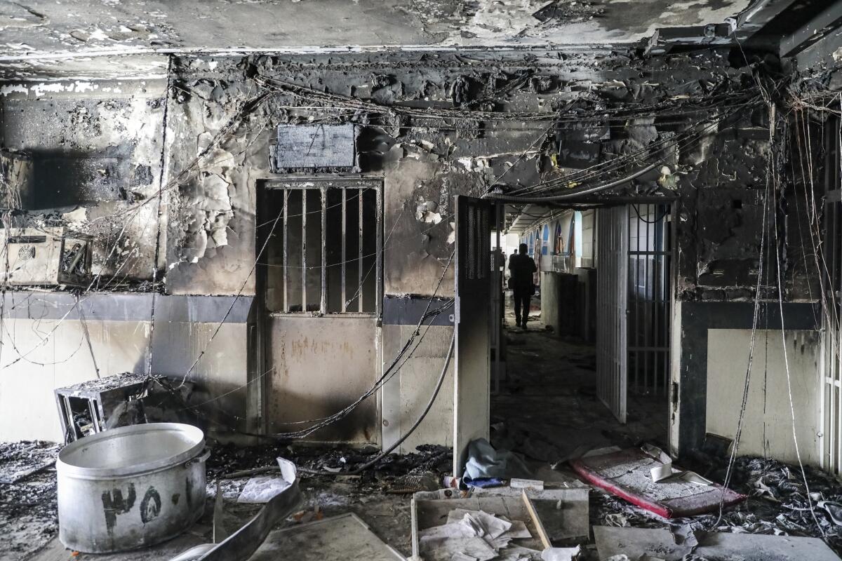 A burnt workshop of Evin Prison filled with debris following a fire