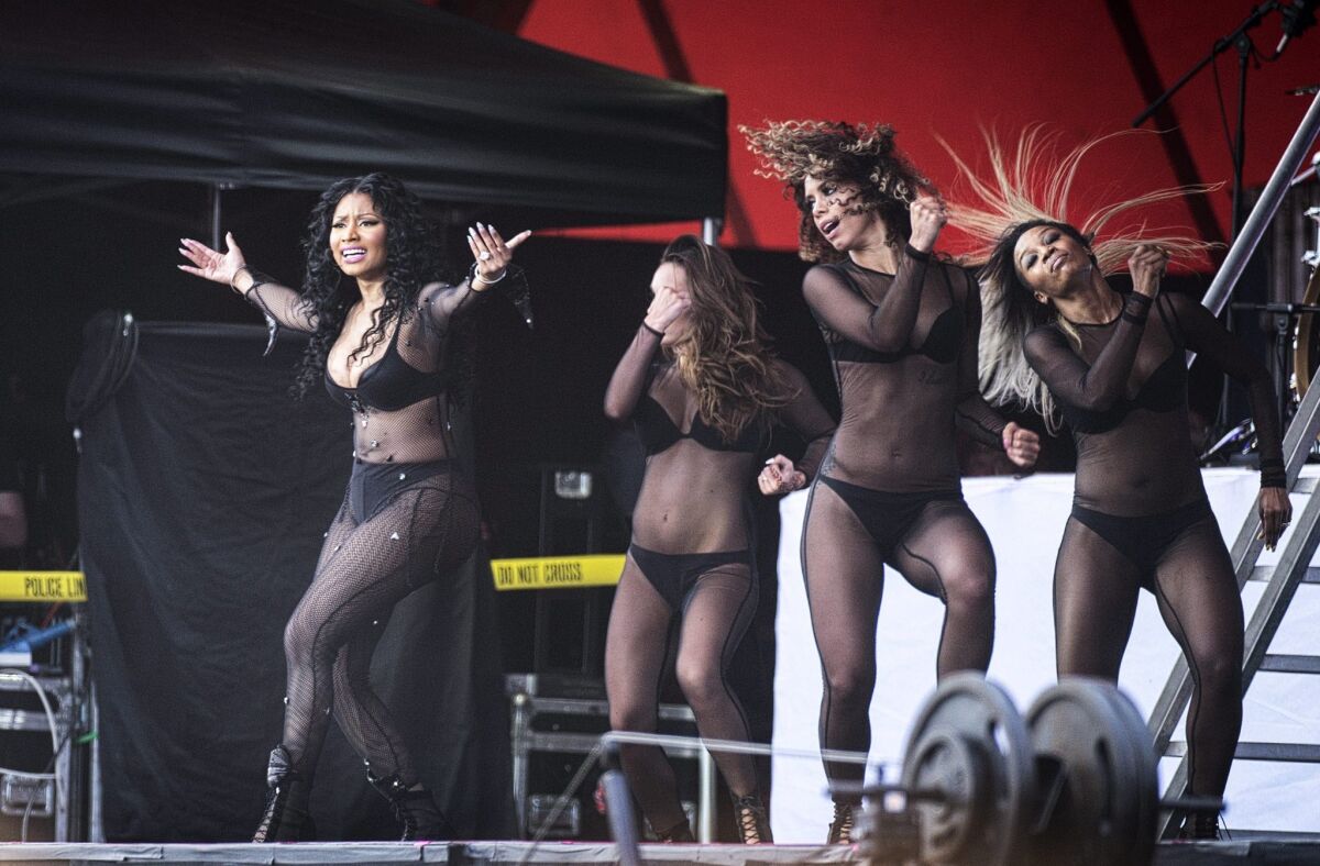 Nicki Minaj, left, performs with dancers at the annual Roskilde Festival, in Roskilde, Denmark, on July 4.