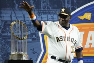 Astros manager Dusty Baker waves at fans after receiving his World Series ring during before a game against the White Sox.