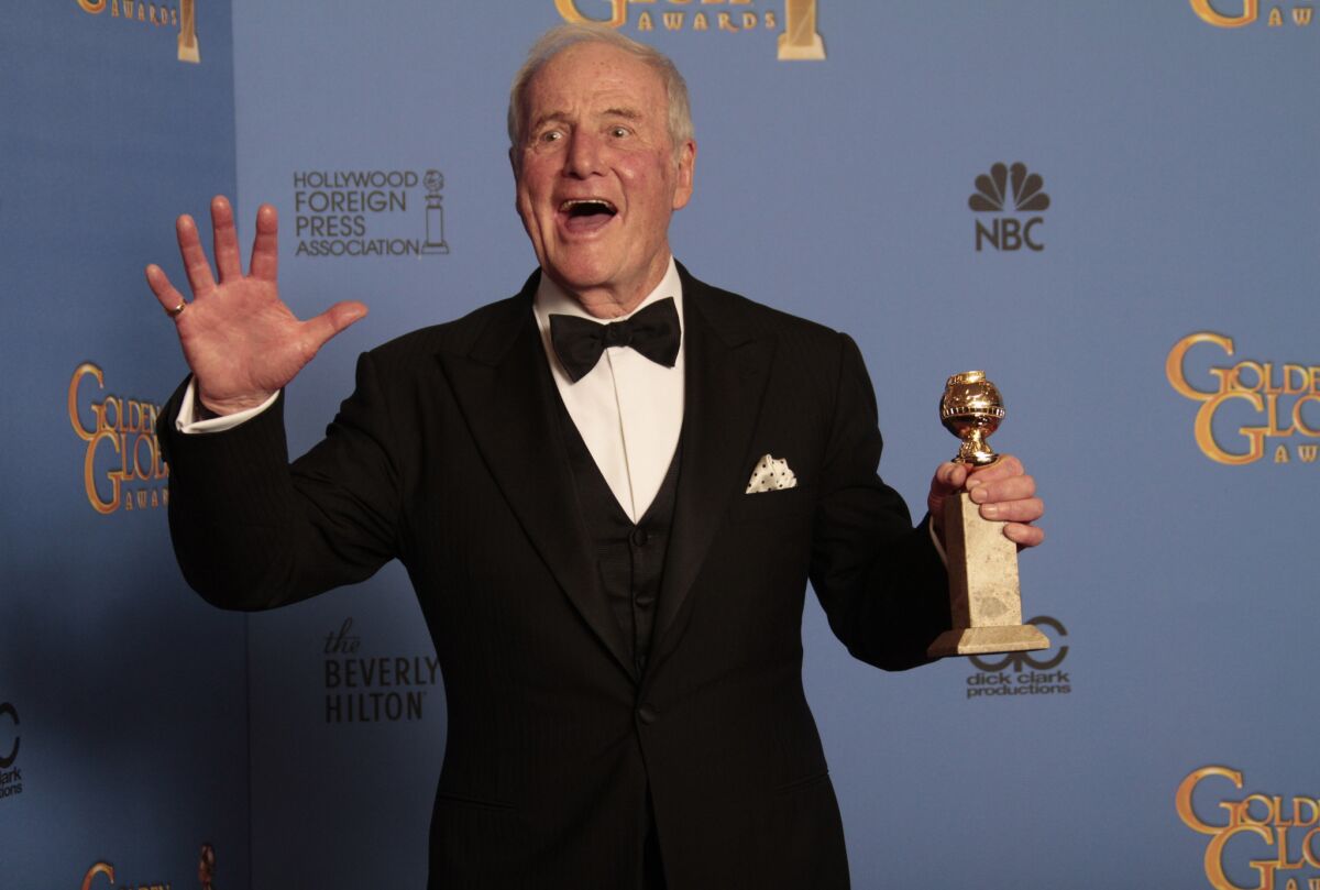 Jerry Weintraub brandishes a statuette backstage at the Golden Globes in 2014, after his Liberace biopic "Behind the Candelabra" won the award for movie or miniseries.