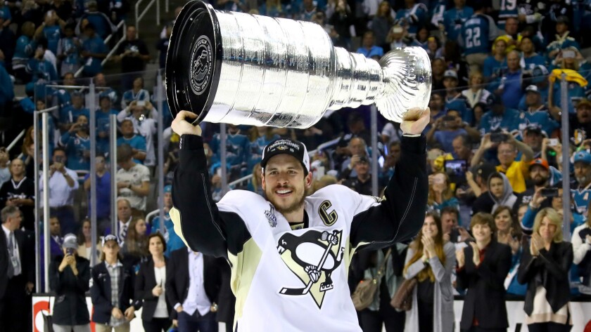 Captain Sidney Crosby hoists Lord Stanley's Cup after the Penguins defeated the Sharks, 3-1, in Game 6 on Sunday in San Jose.