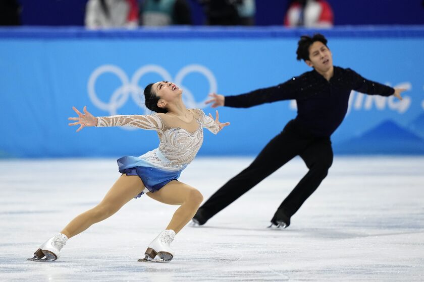 Sui Wenjing and Han Cong, of China, compete in the pairs free skate program.
