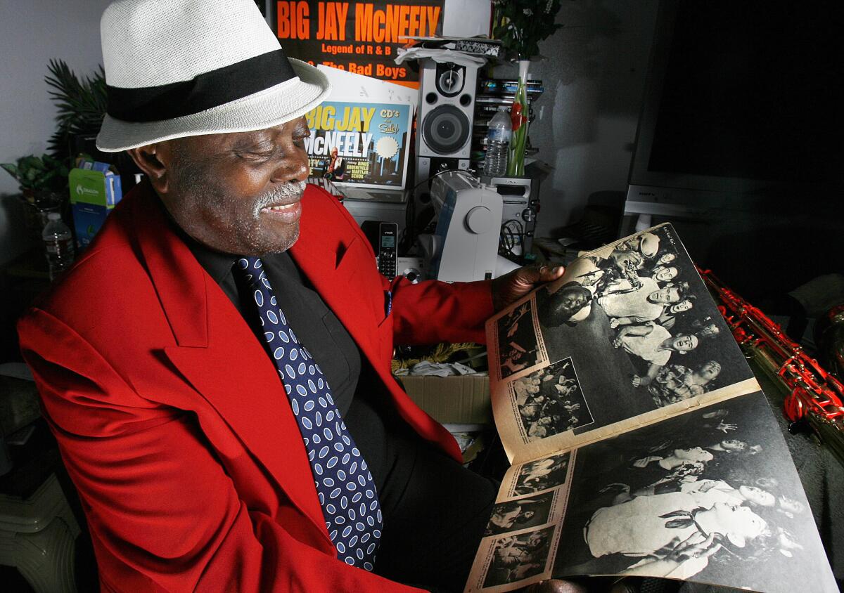Big Jay McNeely holds a 1953 copy of See Magazine with a large picture of him playing saxophone on his back in Los Angeles on Monday, August 6, 2012. McNeely's first hit album was in 1949.