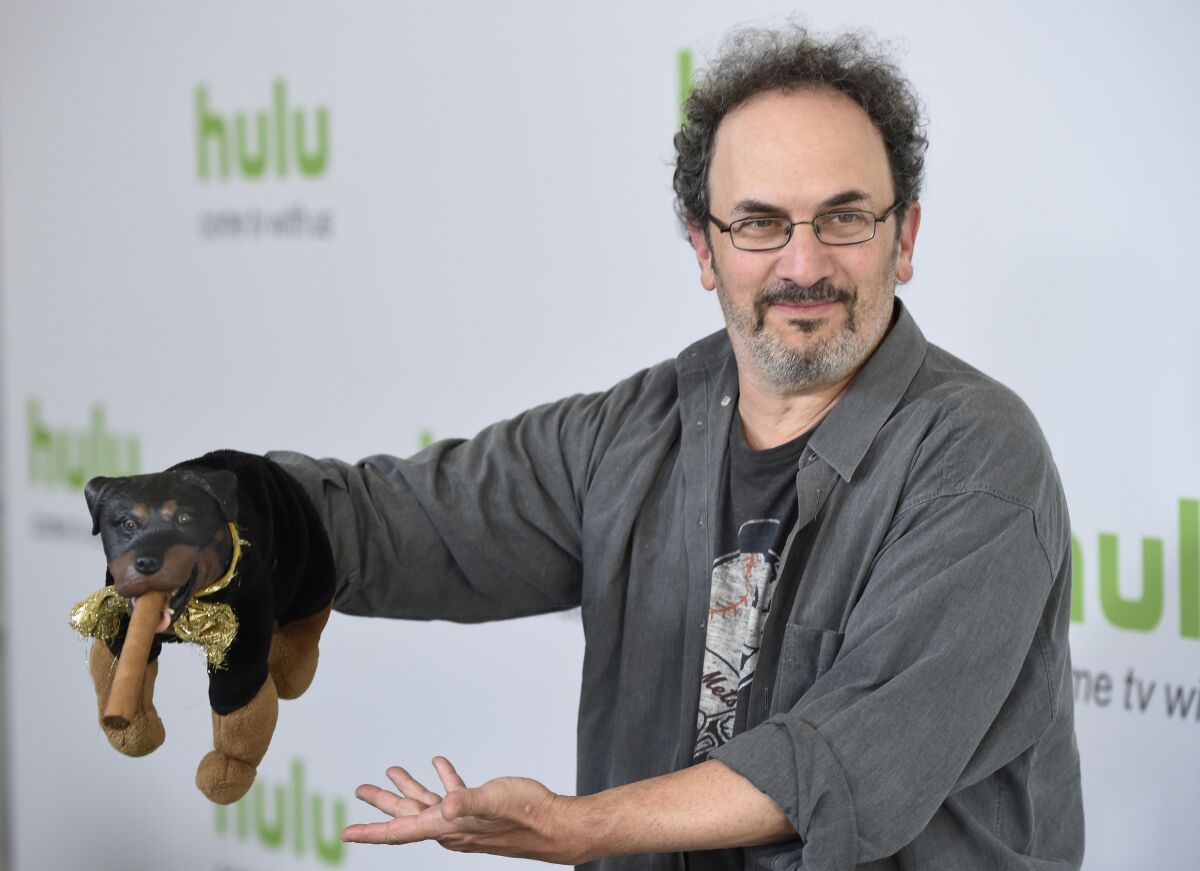 FILE - Robert Smigel, creator, executive producer and voice of "Triumph the Insult Comic Dog," poses with the puppet during the Television Critics Association 2016 Summer Press Tour at the Beverly Hilton on Aug. 5, 2016, in Beverly Hills, Calif. Federal prosecutors on Monday, July 18, 2022, declined to bring charges against Smigel and eight others associated with CBS’ “Late Show with Stephen Colbert” who were arrested in a building in the U.S. Capitol complex last month. (Photo by Chris Pizzello/Invision/AP, File)