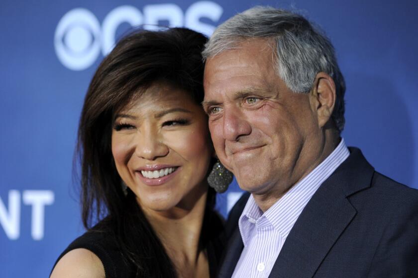 FILE - In this June 16, 2014 file photo, Les Moonves, right, president and CEO of CBS Corporation, and his wife Julie Chen pose together at the premiere of the CBS science fiction television series "Extant" in Los Angeles. Chen returned to television with an unusual sign-off days after her husband, Les Moonves, resigned as CBS CEO following sexual misconduct allegations. The 48-year-old ended Thursday, Sept. 13, 2018 Big Brother broadcast by saying, From outside the Big Brother house, Im Julie Chen Moonves. Good night. Usually, she just says Julie Chen. (Photo by Chris Pizzello/Invision/AP, File)