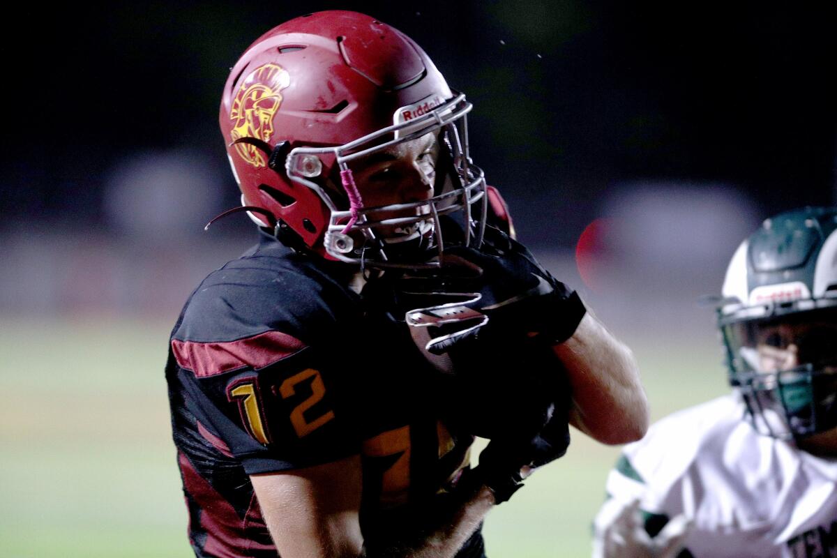 La Canada High School football player #12 Dezin Delgatty grabs one in the end zone for a touch down in game vs. Temple City High School, at home in La Canada Flintridge on Friday, Oct. 4, 2019.