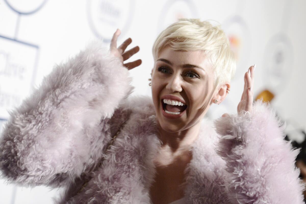 Miley Cyrus, shown in this file shot arriving at the 56th annual Grammy Awards earlier this month, turned to shopping to alleviate hospital boredom.