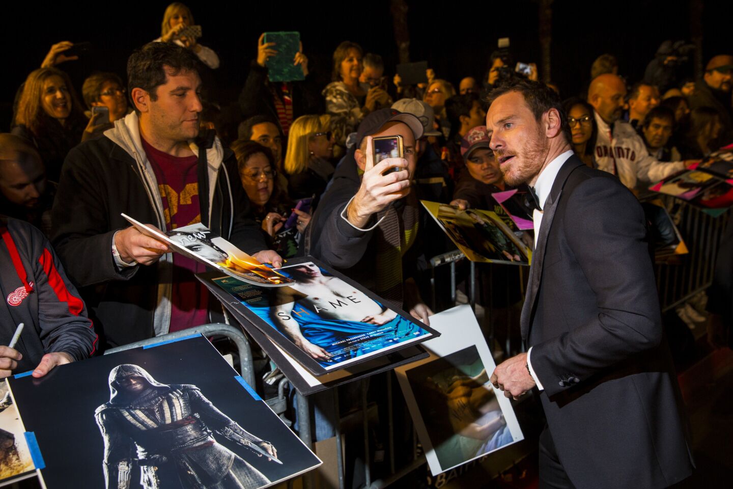 "Steve Jobs" actor Michael Fassbender signs autographs and takes selfies.