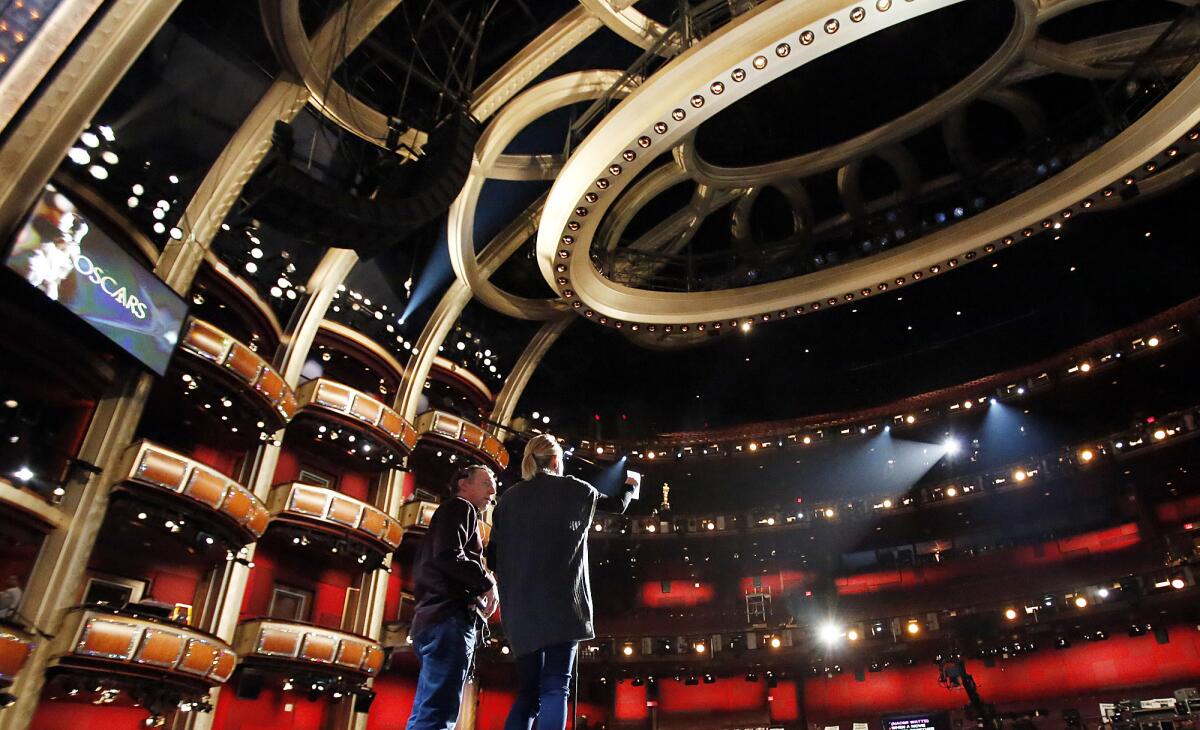 Actress Naomi Watts, right, works with lead stage manager Gary Natoli during rehearsals inside the Dolby Theatre.