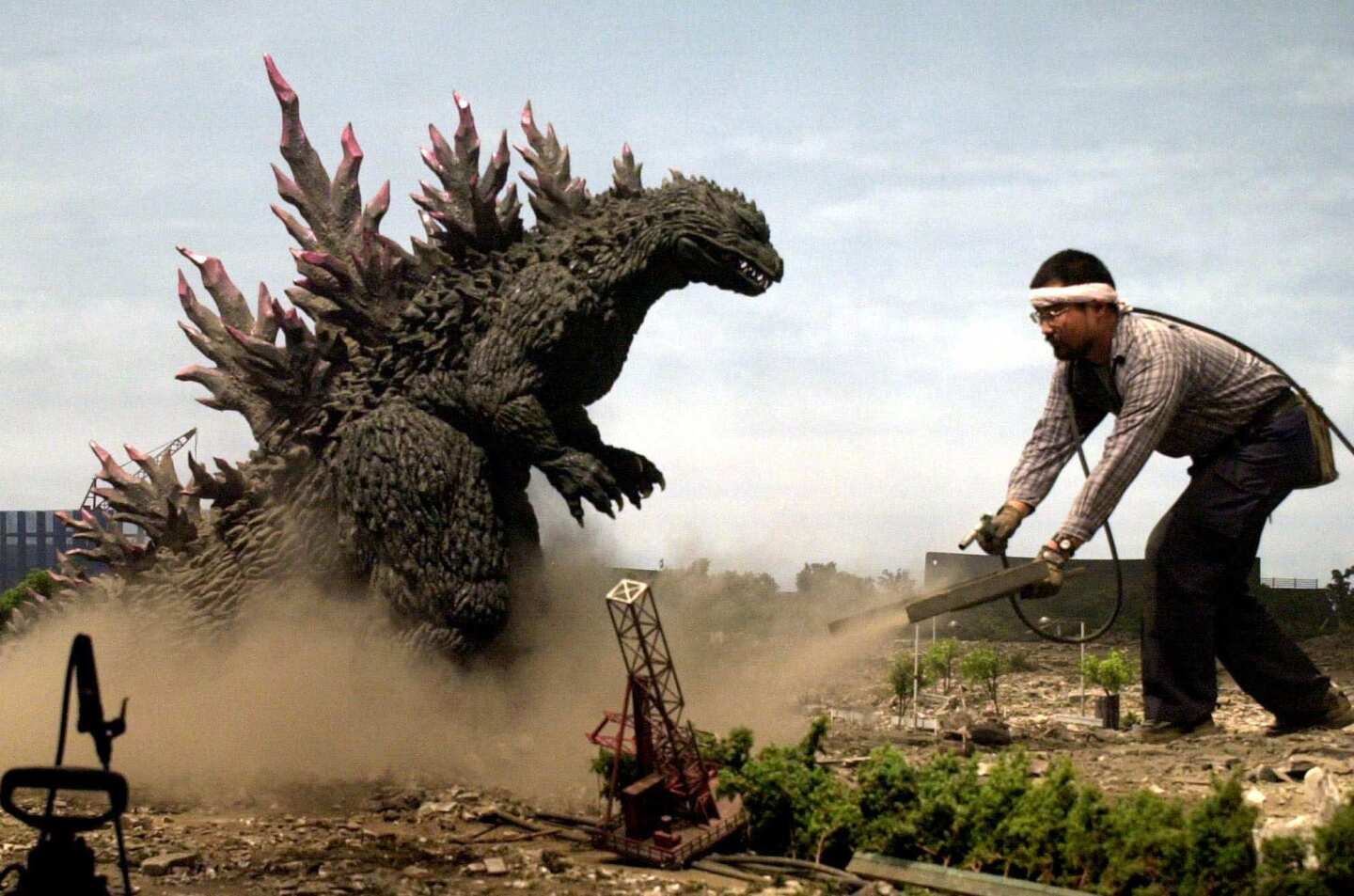 The legendary movie monster Godzilla creates a dust storm during the production of the Toho production company's 24th Godzilla movie at its studio in Tokyo on Aug. 3, 2000. During the production of "Godzilla vs. Megaguirus," 1,500 of the monster's fans applied to a week-long "see Godzilla filming" tour organized by Toho and a travel agency.