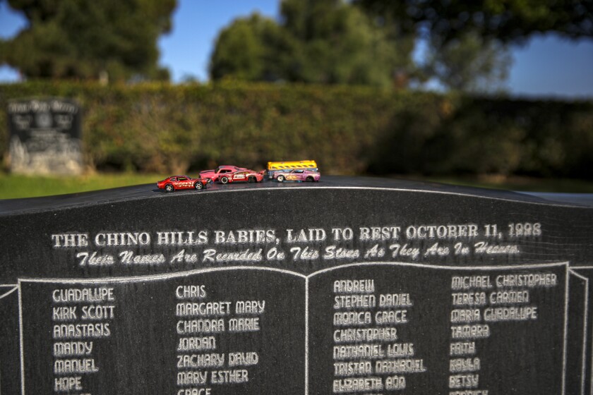 A list of baby names on a memorial stone for fetuses.