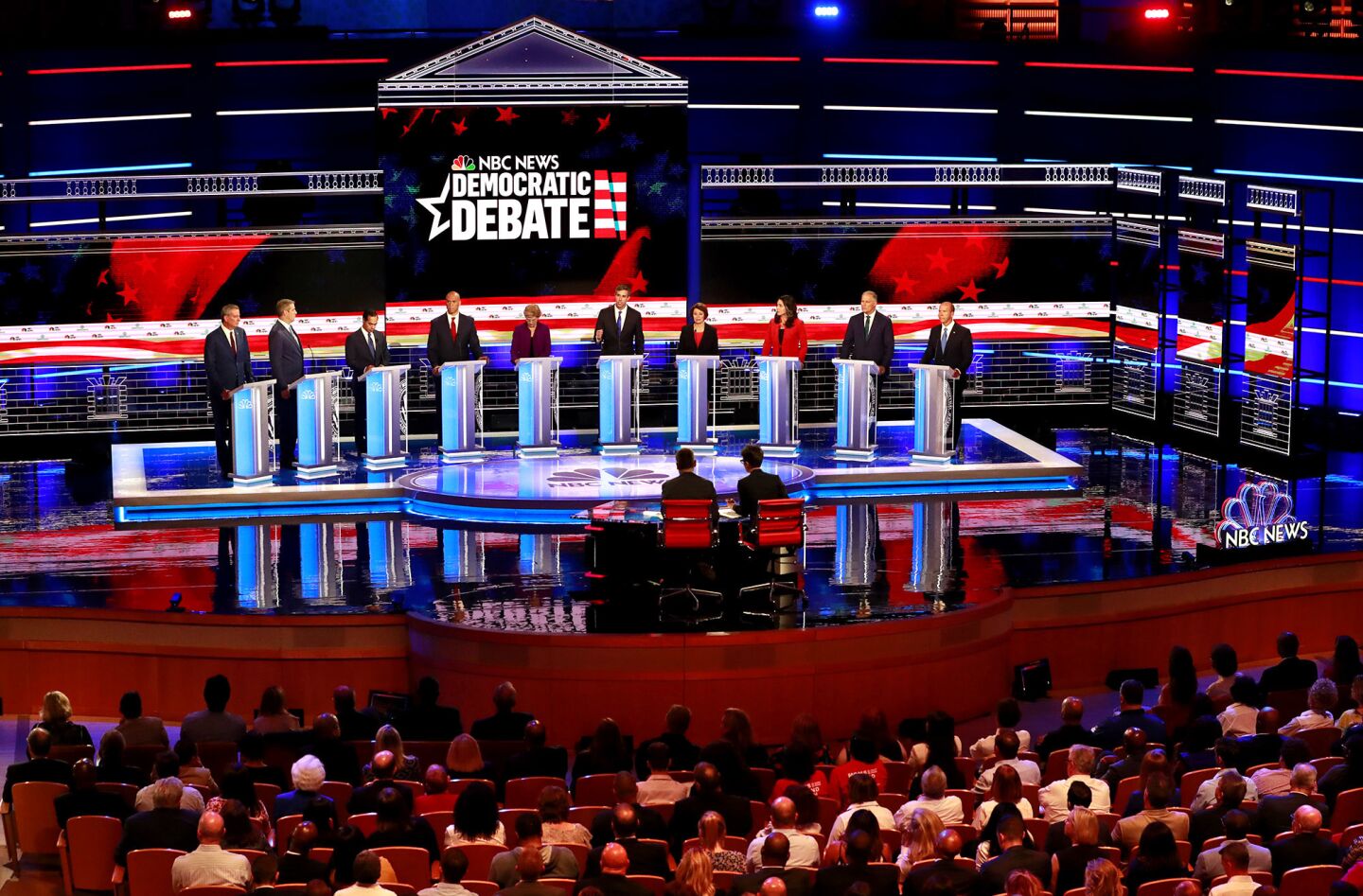 Democratic presidential candidates from left, New York City Mayor Bill de Blasio, Rep. Tim Ryan, D-Ohio, former Housing and Urban Development Secretary Julian Castro, Sen. Cory Booker, D-N.J., Sen. Elizabeth Warren, D-Mass., former Texas Rep. Beto OíRourke, Sen. Amy Klobuchar, D-Minn., Rep. Tulsi Gabbard, D-Hawaii, Washington Gov. Jay Inslee, and former Maryland Rep. John Delaney listen to a question during the Democratic primary debate hosted by NBC News at the Adrienne Arsht Center for the Performing Arts, Wednesday, June 26, 2019, in Miami.