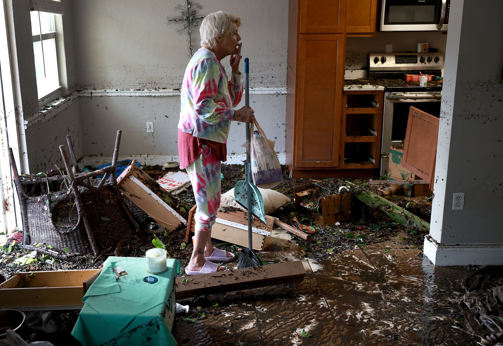 =Stedi Scuderi looks over her apartment after flood water inundated it when Hurricane Ian passed through Fort Myers, Florida
