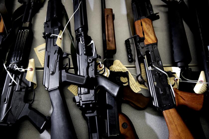 FILE - In this Oct. 9, 2018, file photo, Illegally possessed firearms seized by authorities are displayed during a news conference in Los Angeles. State authorities cleared 8.6% fewer cases last year into people who are no longer are allowed to own firearms, down from a record high in 2018, through a unique California program according to a California Department of Justice report released Wednesday, April 1, 2020. (AP Photo/Jae C. Hong, File)