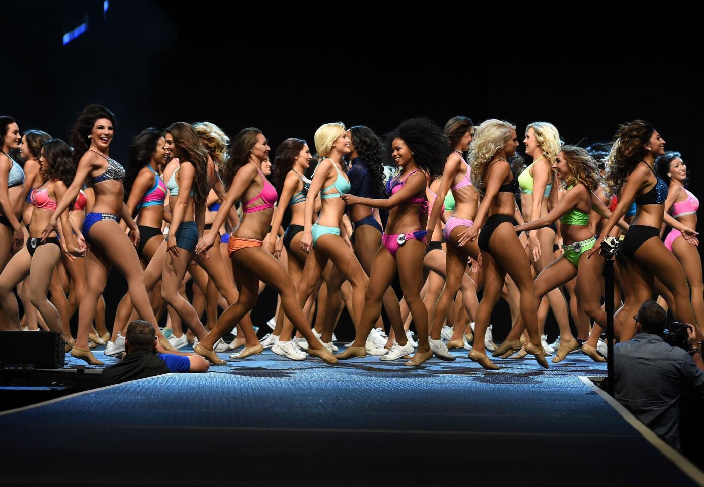 TOPSHOT - Cheerleading candidates parade on stage during the Los Angeles Rams Cheerleading Final auditions at the Forum in Los Angeles, California on April 17, 2016. The St. Louis Rams, relocated to Los Angeles for the 2016 season, have chosen 30 new cheerleaders from the city. / AFP PHOTO / Mark RalstonMARK RALSTON/AFP/Getty Images ** OUTS - ELSENT, FPG, CM - OUTS * NM, PH, VA if sourced by CT, LA or MoD **