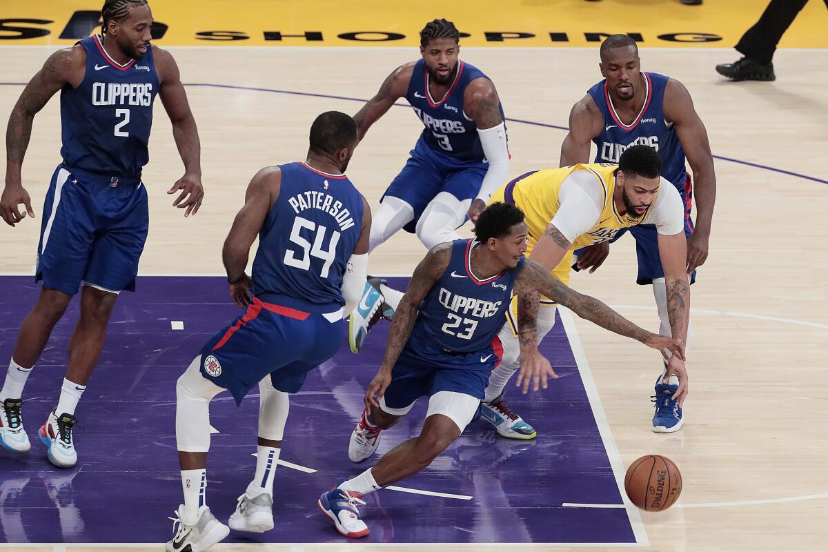 Clippers guard Lou Williams steals the ball from Lakers forward Anthony Davis during the first half Tuesday night.