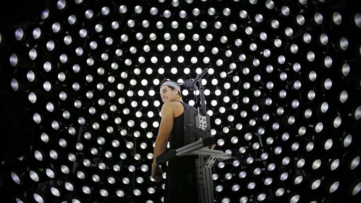 Actor Robbie Amell, surrounded by lights, prepares for a scan of his face to create a digital double of himself at LightStage's studio in Burbank.