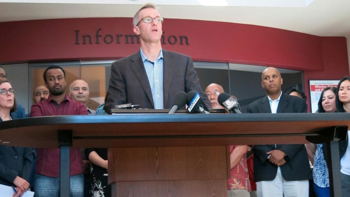 Portland, Ore., Mayor Ted Wheeler speaks at a news conference on Saturday after a man fatally stabbed two men on a light-rail train.