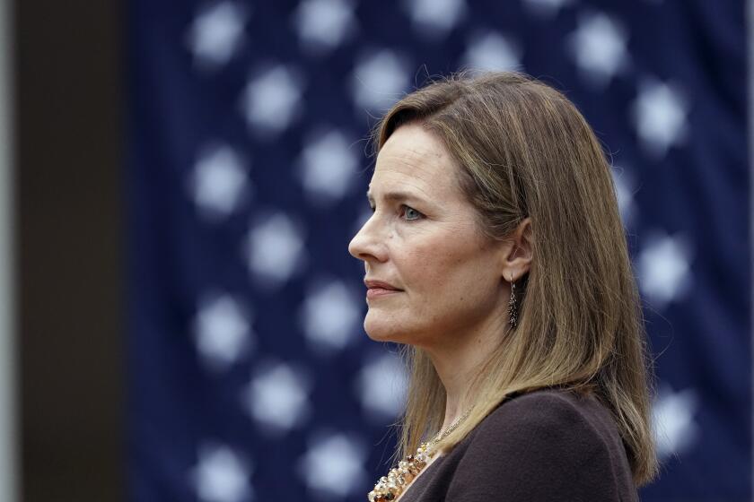 Judge Amy Coney Barrett listens as President Donald Trump announces Barrett as his nominee to the Supreme Court, in the Rose Garden at the White House, Saturday, Sept. 26, 2020, in Washington. (AP Photo/Alex Brandon)