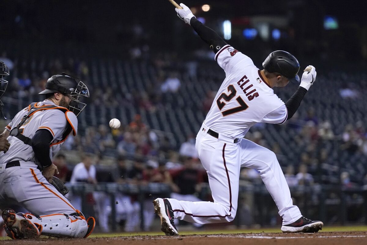 Arizona Diamondbacks' Drew Ellis (27) strikes out as San Francisco Giants catcher Curt Casali, left, blocks the ball from getting past him during the first inning of a baseball game, Thursday, Aug. 5, 2021, in Phoenix. (AP Photo/Ross D. Franklin)