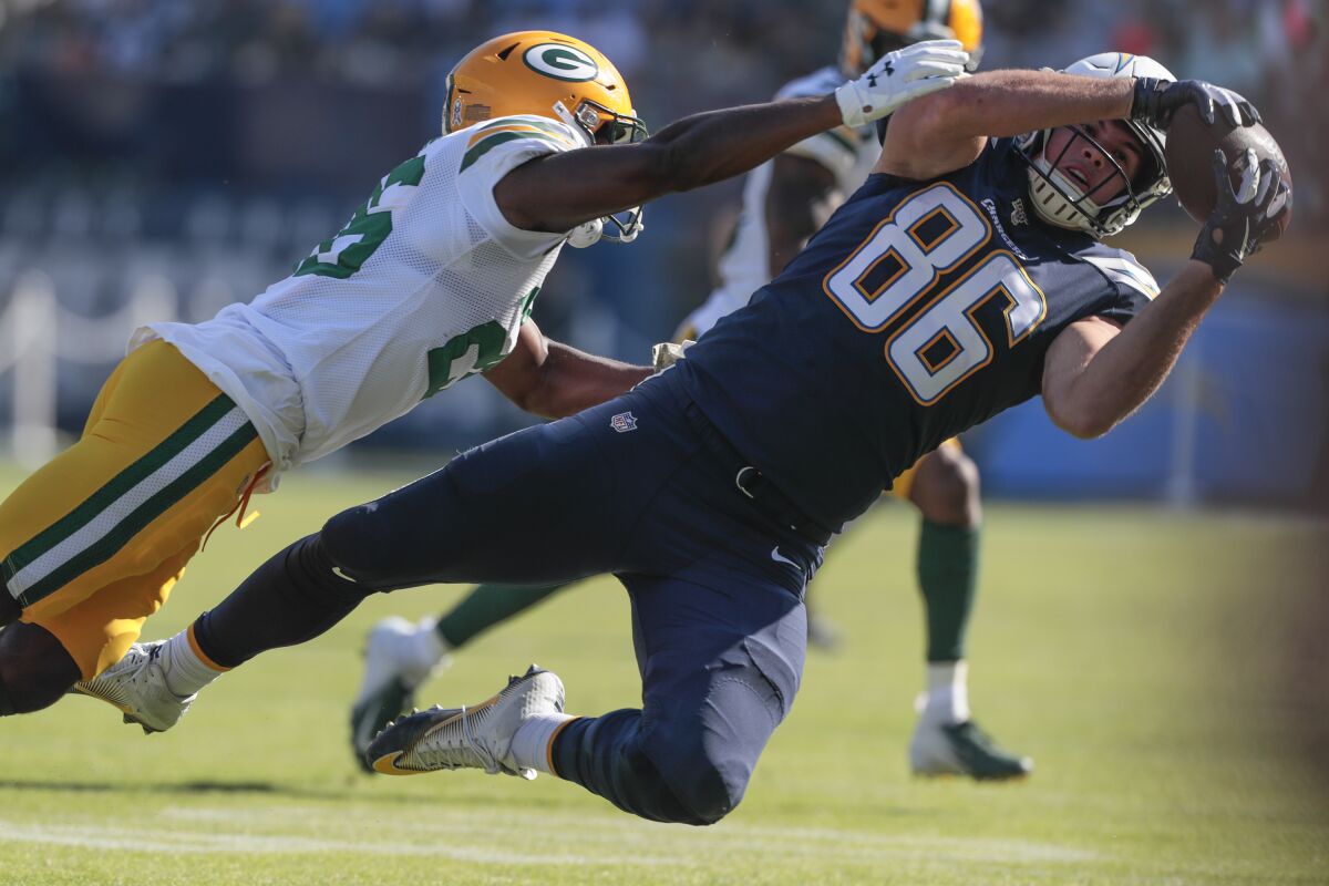 Chargers tight end Hunter Henry makes a catch while covered by Packers defensive back Darnell Savage during a game Nov. 3, 2019, at Dignity Health Sports Park.