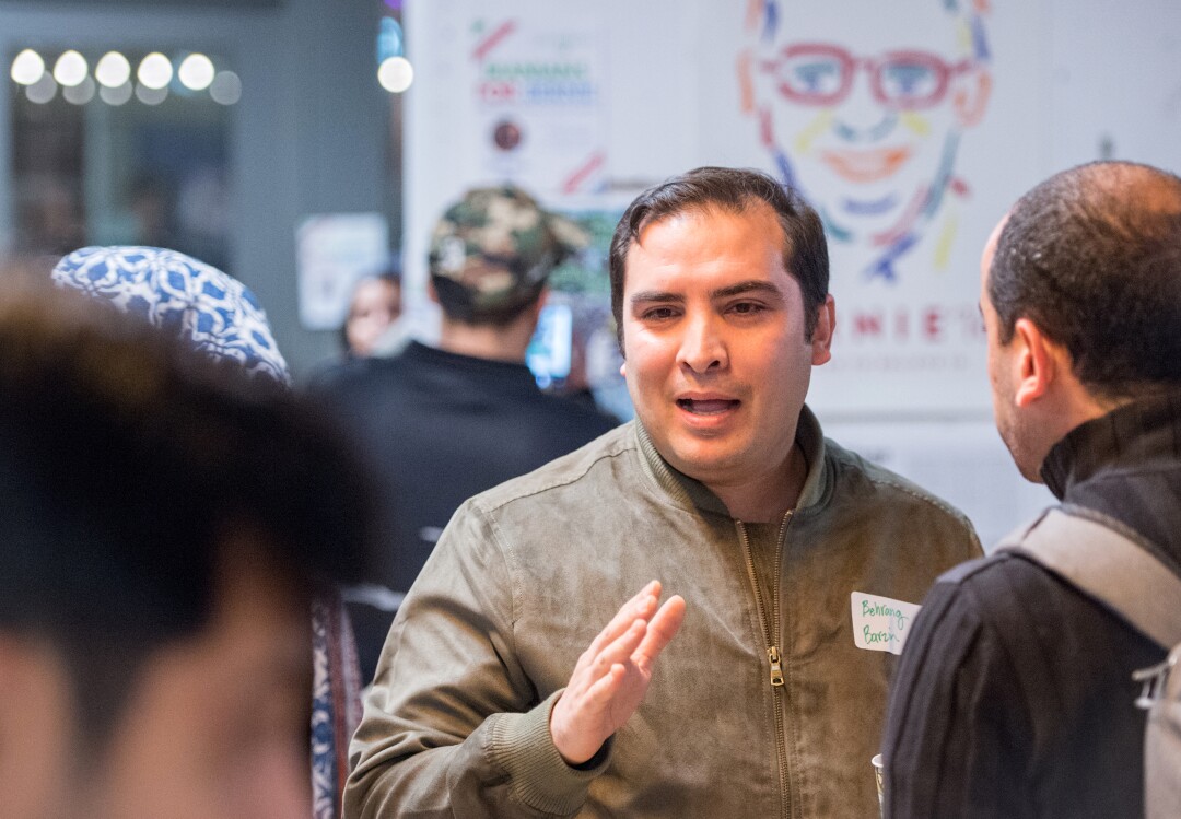 Behrang Barzin speaks to other attendees at an “Iranians for Bernie” meeting in Oakland.