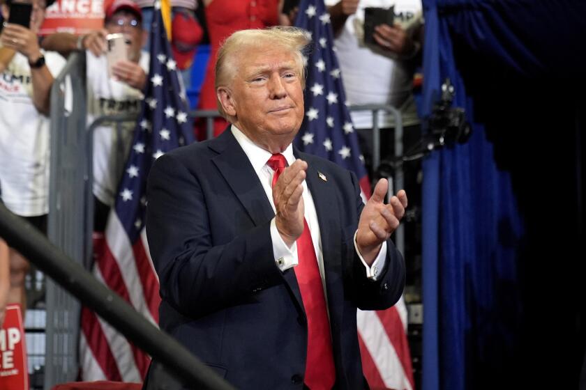 Republican presidential candidate former President Donald Trump claps at a campaign rally at Georgia State University in Atlanta, Saturday, Aug. 3, 2024. (AP Photo/John Bazemore)