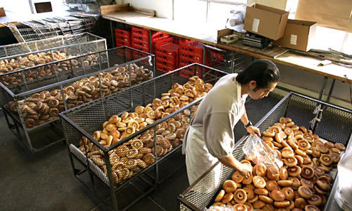 GOLDEN GLOW: Bagels fresh from the oven are prepared for shipping to customers at Brooklyn Bagel, a 55-year-old L.A. bakery.