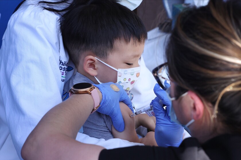 LOS ANGELES CA JUNE 21, 2022 - Aevin Lee, 2, son of Dr. Jennifer Su, cardiologist, receives the Pfizer COVID vaccine on Tuesday, June 21, 2022 at Children's Hospital Los Angeles. (Wesley Lapointe / Los Angeles Times)