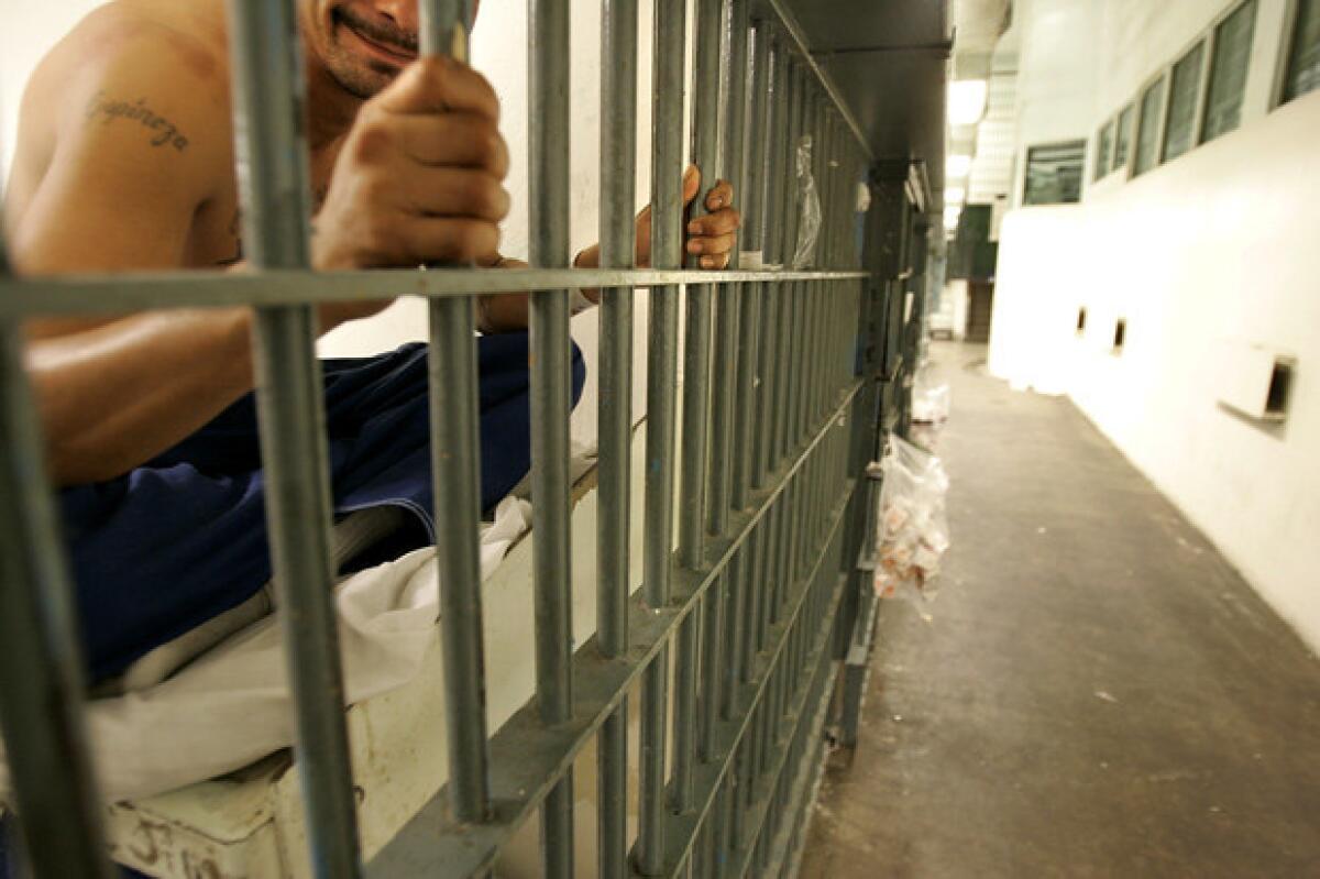 An inmate peers from his cell at the Men's Central Jail. 