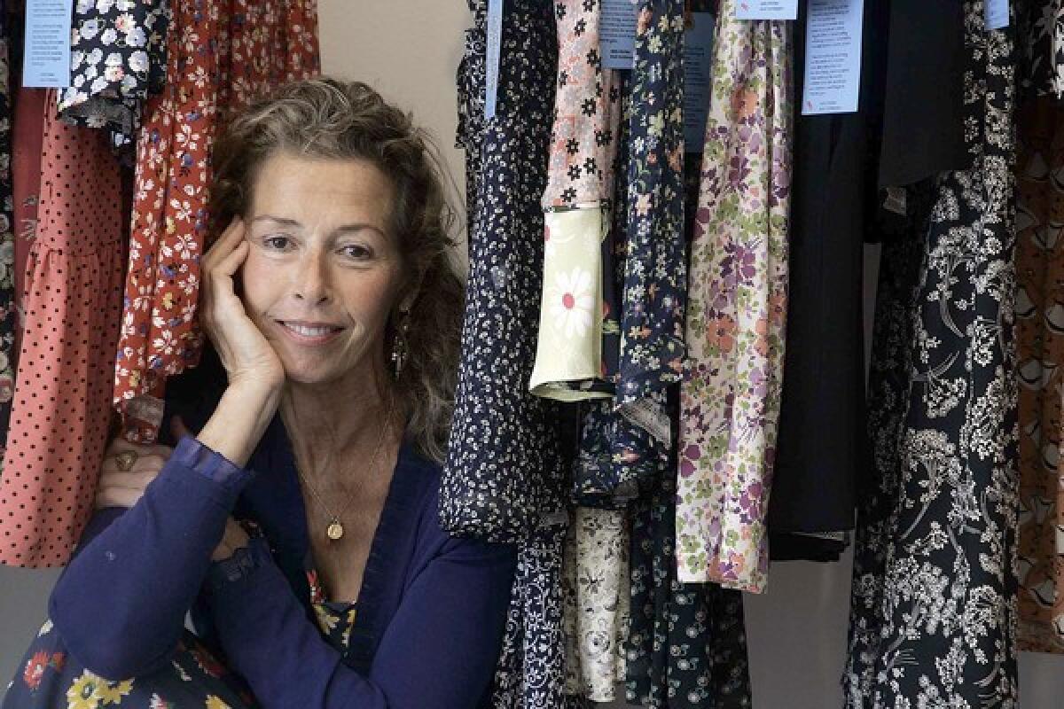 Gale Parker poses in her boutique among rayon dresses she designed.