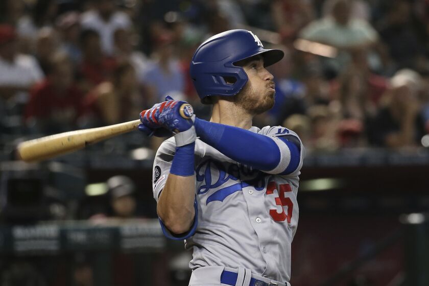 Los Angeles Dodgers' Cody Bellinger watches the flight of his home run against the Arizona Diamondbacks during the ninth inning of a baseball game Sunday, Sept. 1, 2019, in Phoenix. (AP Photo/Ross D. Franklin)