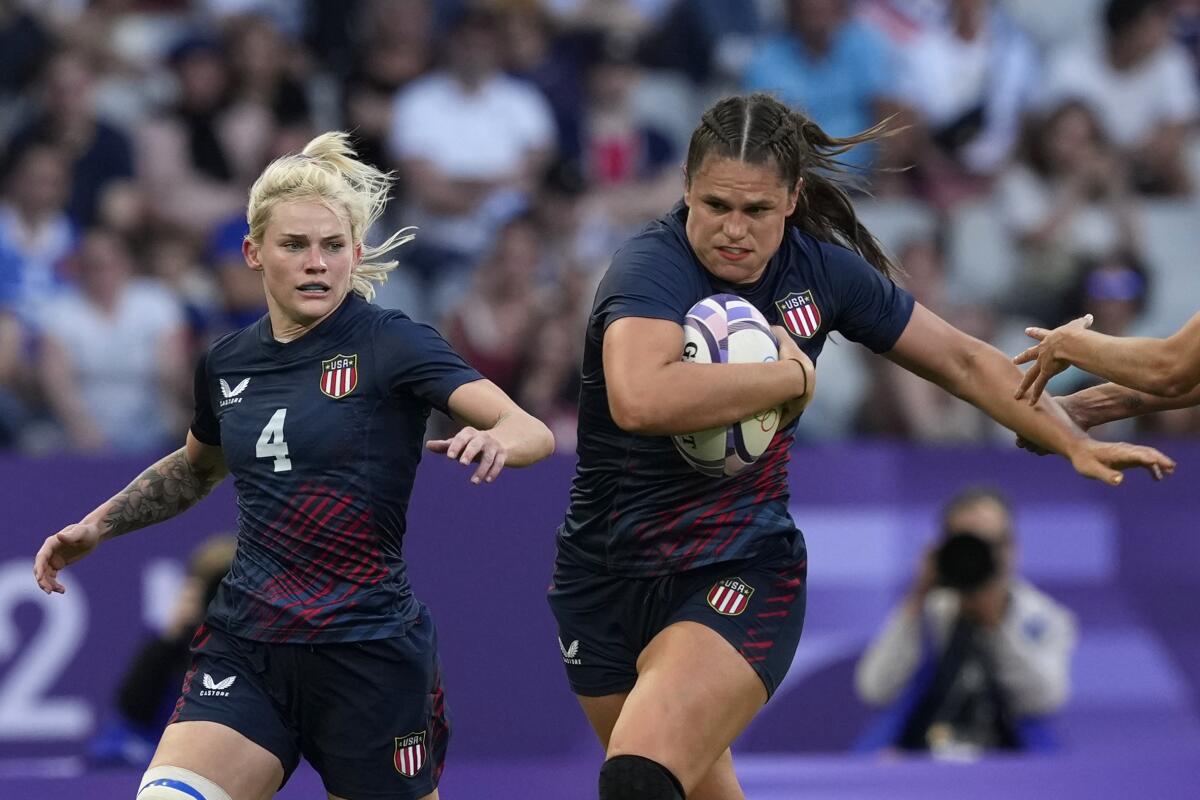 United States' Ilona Maher, fends off the tackle of Brazil's Gabriela Lima, right.