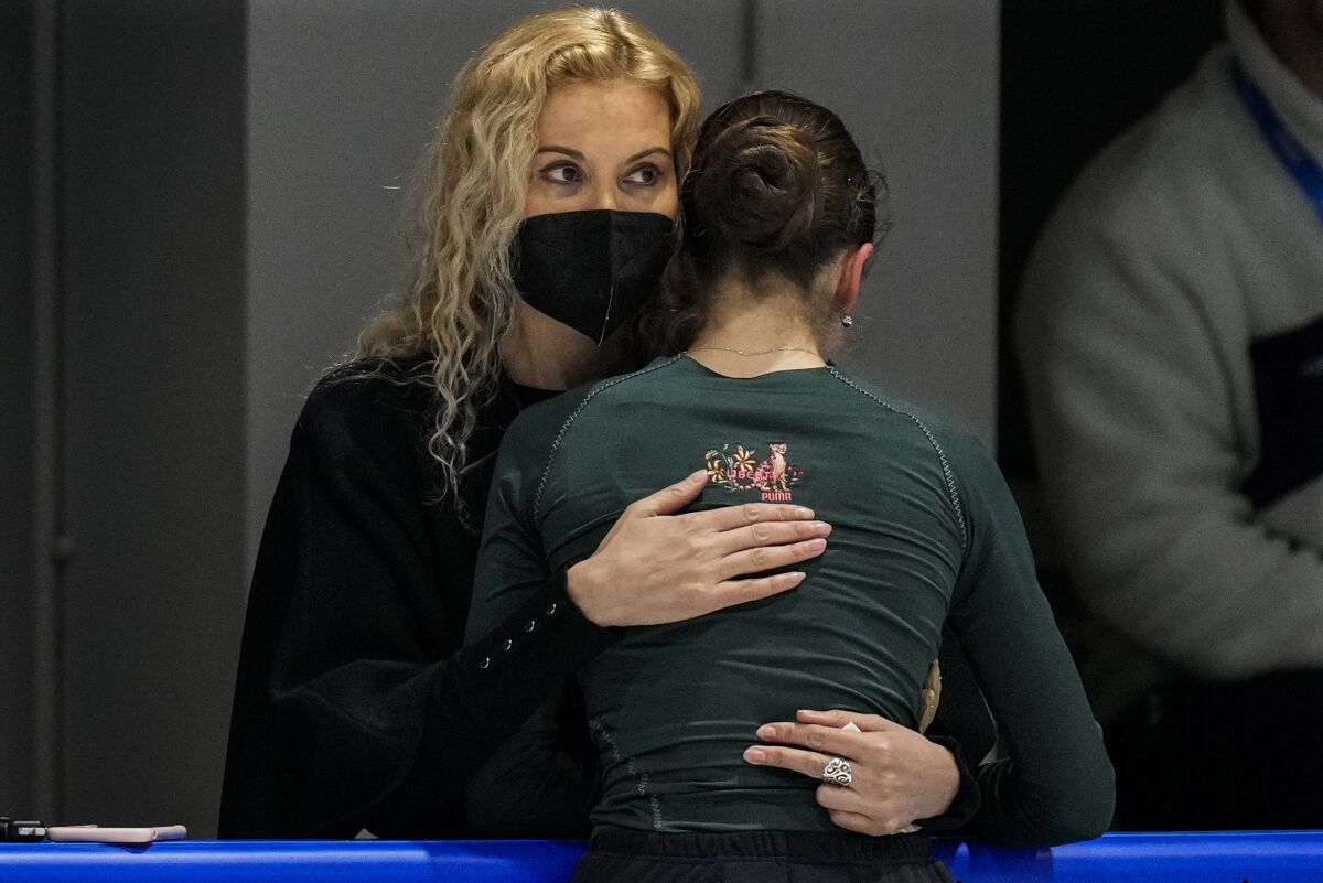 Coach Eteri Tutberidze, left, embraces Kamila Valieva, of the Russian Olympic Committee, during a training session at the 2022 Winter Olympics, Saturday, Feb. 12, 2022, in Beijing. (AP Photo/Bernat Armangue)